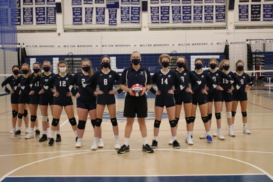 Coach Liptack and the Freshman volleyball team pose for a powerful picture.